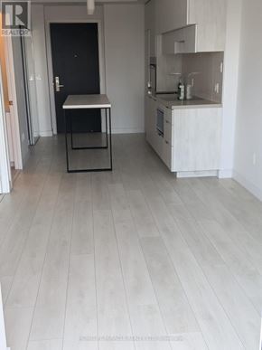 Toronto (Yonge-Eglinton) condo for rent - A kitchen with a table and a fridge.