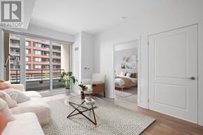 Vaughan condo for rent - A modern living room with a large window and a view of a building outside.