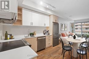 Vaughan condo for rent - A modern kitchen with a dining table and chairs.