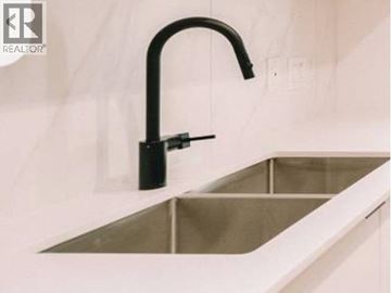 Port Moody apartment for rent - A modern kitchen sink with a black faucet.