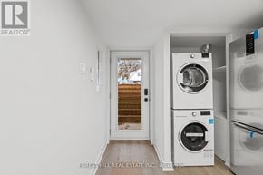 Toronto (Beechborough-Greenbrook) apartment for rent - A laundry room with a washer and dryer stacked on top of each other.