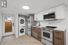 Toronto (Beechborough-Greenbrook) apartment for rent - A kitchen with white cabinets and stainless steel appliances.
