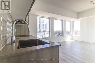 Oakville (Jm Joshua Meadows) condo for rent - A modern kitchen with a stainless steel sink and a brick wall.