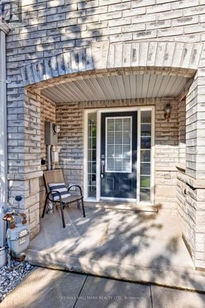 Ajax (Central East) townhouse for rent - A patio with a chair and table outside a house.