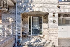 Ajax (Central East) townhouse for rent - A house number 10 with a glass door and a small patio.