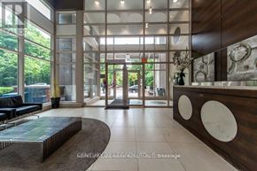 Toronto (Bendale) condo for rent - A reception area with a wooden counter and a glass wall.