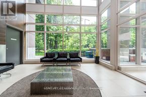 Toronto (Bendale) condo for rent - A living room with a couch and a rug in front of a glass wall.