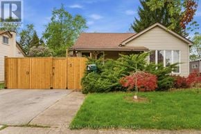Welland (Broadway) apartment for rent - A house with a brown fence and a green bush in front.