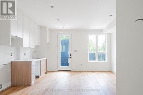 Toronto (Oakwood Village) multi-family for rent - A white room with a blue door and a window.