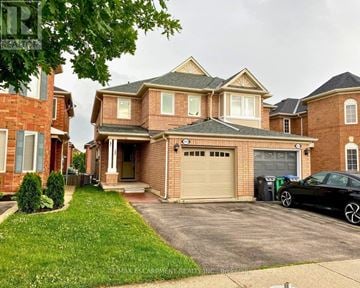 Mississauga (Lisgar) apartment for rent - A house with a black car parked in front of it.