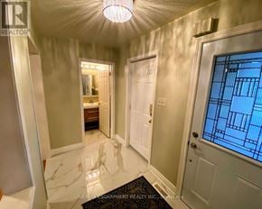 Mississauga (Lisgar) apartment for rent - A hallway with a marble floor and a stained glass door.