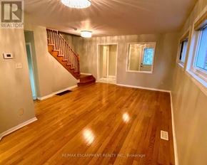 Mississauga (Lisgar) apartment for rent - A spacious room with wooden flooring and a staircase.