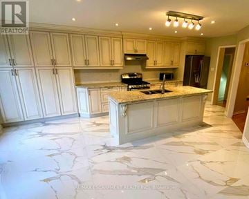 Mississauga (Lisgar) apartment for rent - A kitchen with white cabinets and marble flooring.