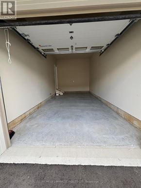 Tillsonburg townhouse for rent - A storage unit with a concrete floor and white walls.