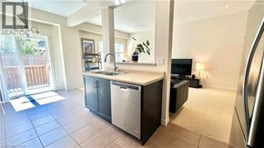 Grimsby townhouse for rent - A kitchen with a sink and a refrigerator.
