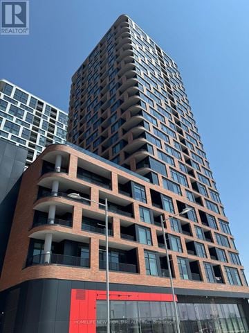 Markham (Unionville) condo for rent - A tall building with a red sign that says "HOMELIFE NEW WORLD REAL ESTATE Brokerage".