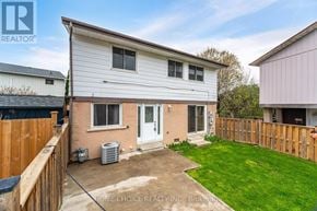 Brampton (Central Park) apartment for rent - A house with a fence and a green lawn in front.