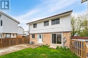 Brampton (Central Park) apartment for rent - A house with a white exterior and a brown fence is for sale.