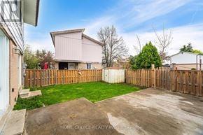 Brampton (Central Park) apartment for rent - A backyard with a wooden fence and a shed.