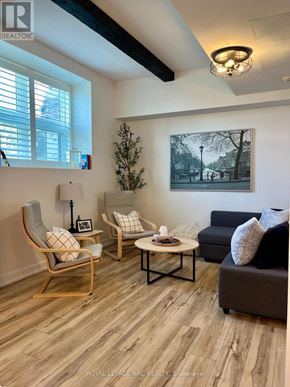 St. Catharines (Oakdale) condo for rent - A living room with a couch, chair, and table.