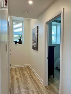 St. Catharines (Oakdale) condo for rent - A hallway with a wooden floor and white walls.