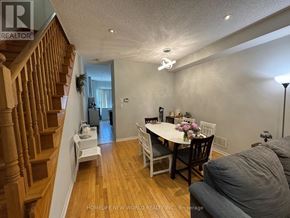 Toronto (Newtonbrook West) townhouse for rent - A dining room with a table set for two and a couch.