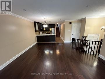 Markham (Milliken Mills West) apartment for rent - A spacious room with wooden floors and a staircase.