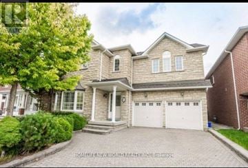 Markham (Berczy) apartment for rent - A large, well-maintained house with a brick exterior and a white garage door.