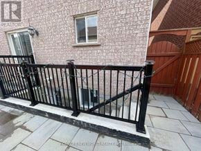 Markham (Berczy) apartment for rent - A black metal railing on a concrete patio.