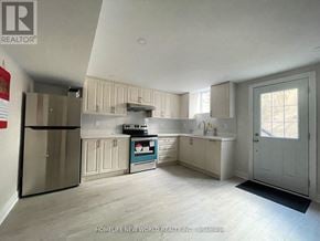 Markham (Berczy) apartment for rent - A kitchen with a refrigerator, oven, and cabinets.
