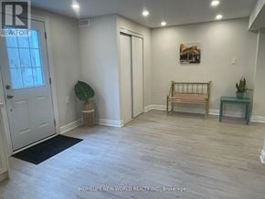 Markham (Berczy) apartment for rent - A room with a white door, a bench, and a plant.