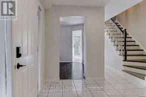 Oakville (Wc Wedgewood Creek) apartment for rent - A hallway with a staircase and a door leading to a balcony.