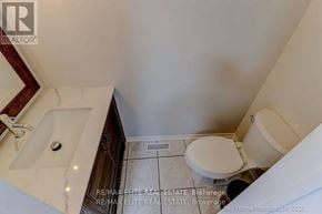 Oakville (Wc Wedgewood Creek) apartment for rent - A bathroom with a toilet, sink, and mirror.
