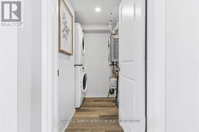 Niagara Falls (Morrison) townhouse for rent - A brokerage sign is on the wall of a laundry room.