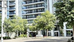 Toronto (Lansing-Westgate) condo for rent - A large building with a sign that says "REALTOR" on it.