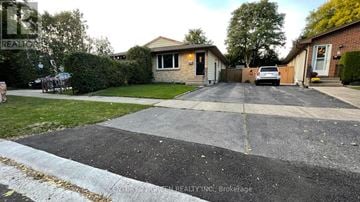 London North (North F) apartment for rent - A residential street with houses and a car parked on the driveway.