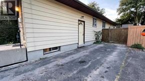 London North (North F) apartment for rent - A house with a white door and a brown fence is for sale.