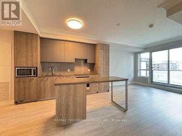 Markham (Unionville) condo for rent - A modern kitchen with wooden cabinets and a large island.