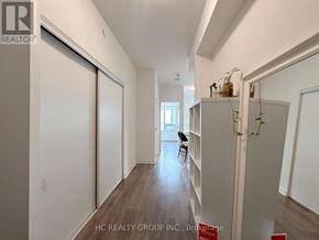 Toronto (Mount Pleasant West) condo for rent - A long hallway with a chair and a plant on the shelf.