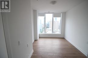Toronto (Kensington-Chinatown) condo for rent - A room with a window that has a view of a city.