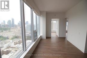 Toronto (Kensington-Chinatown) condo for rent - A room with a view of the cityscape through large windows.