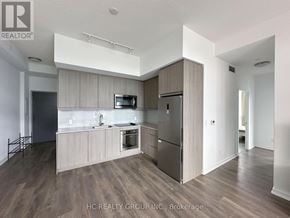 Toronto (Henry Farm) condo for rent - A modern kitchen with wooden cabinets and stainless steel appliances.