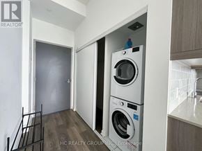 Toronto (Henry Farm) condo for rent - A washer and dryer are stacked on top of each other in a laundry room.