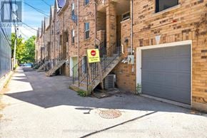 Toronto (Greenwood-Coxwell) townhouse for rent - A narrow street with a "No Parking" sign on a pole.