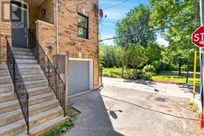 Toronto (Greenwood-Coxwell) townhouse for rent - A house with a stop sign in front of it.