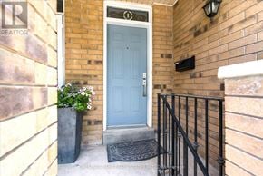 Toronto (Greenwood-Coxwell) townhouse for rent - A blue door is on the right side of a brick wall.