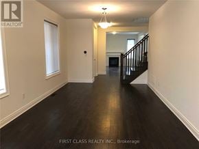 Richmond Hill apartment for rent - A long hallway with a staircase on the right side.
