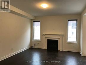 Richmond Hill apartment for rent - A room with a fireplace and two windows.