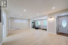 Georgina (Keswick North) apartment for rent - A spacious room with light wood flooring and white walls.