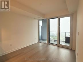 Mississauga (City Centre) condo for rent - A room with a sliding glass door leading to a balcony.